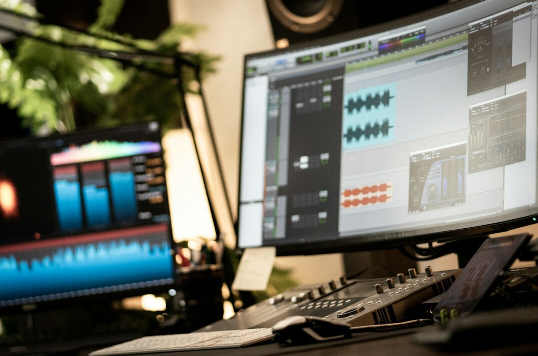 Broadcast control room with live video walls and mixing desks